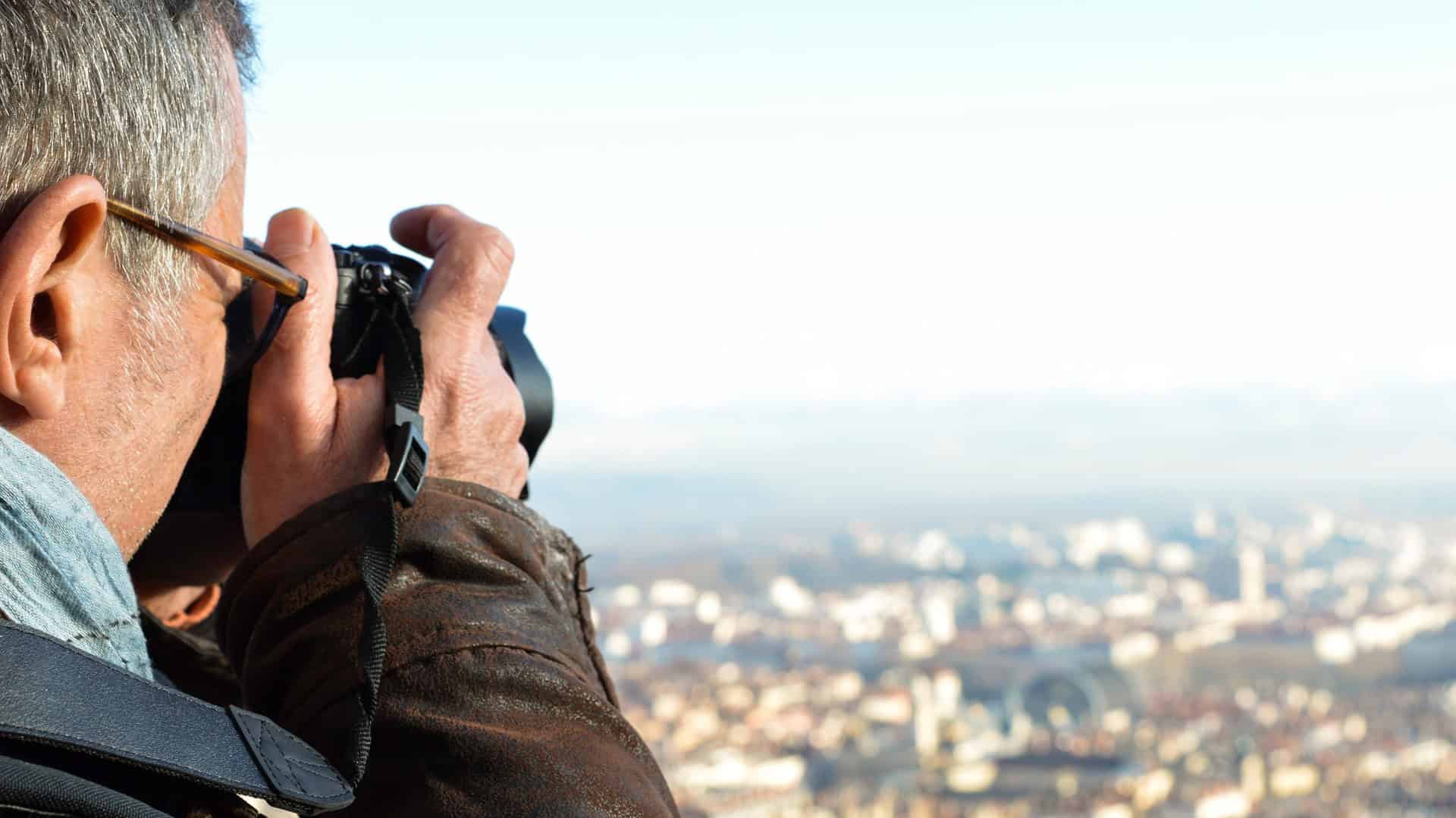 middle aged man taking photos