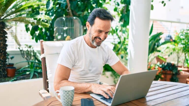 man working on laptop outside