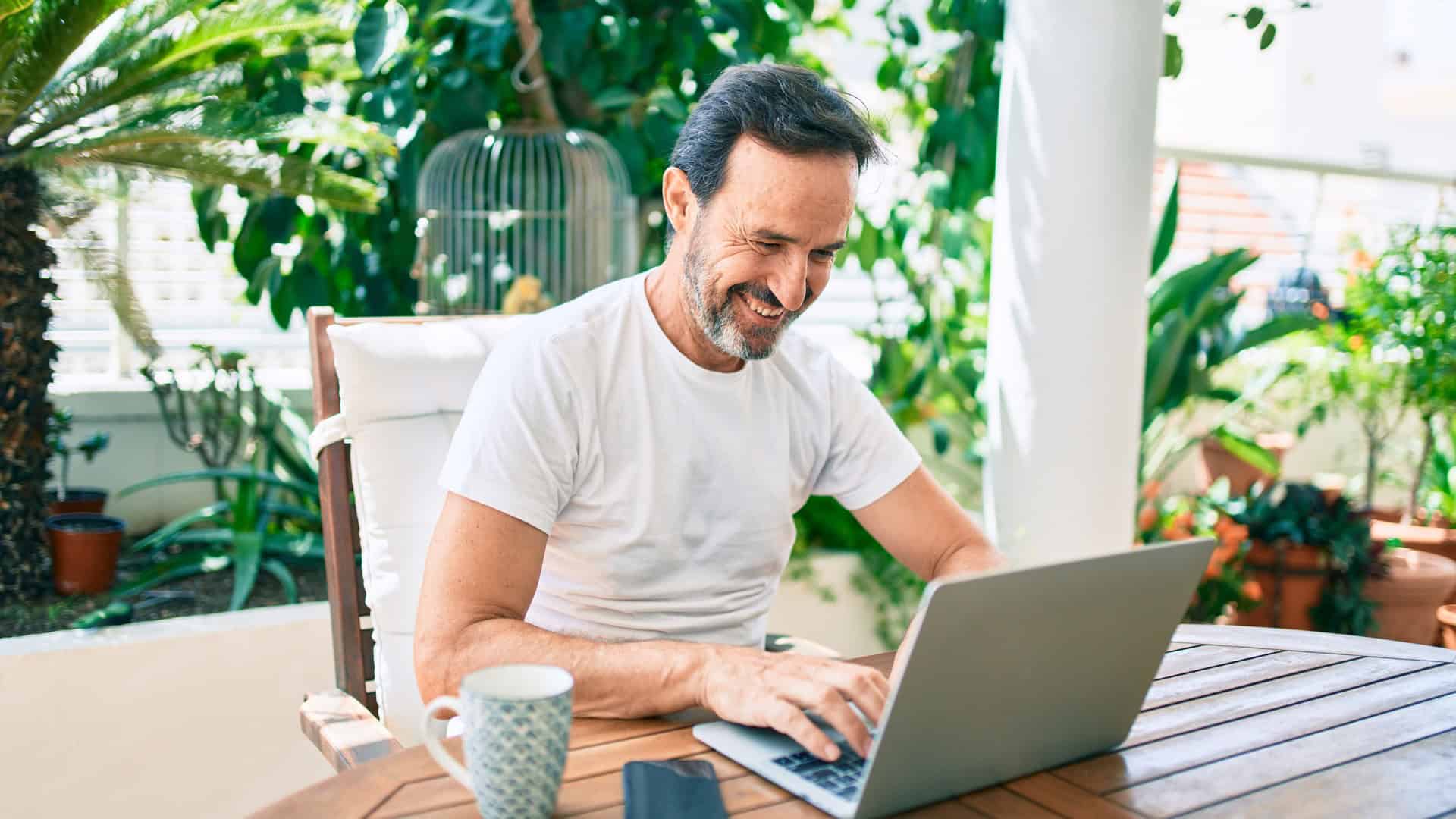 man working on laptop outside