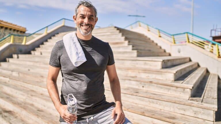 middle aged man working out with water