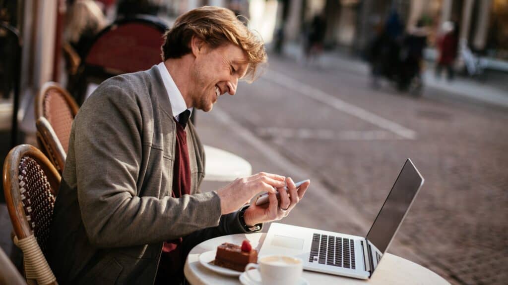 man working outside at cafe