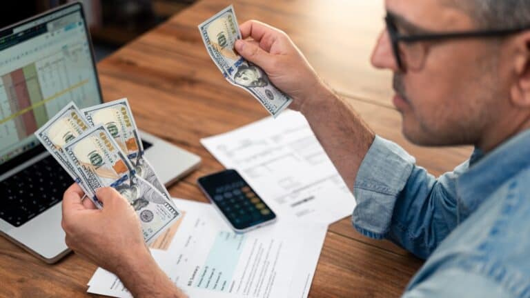 man counting money and saving