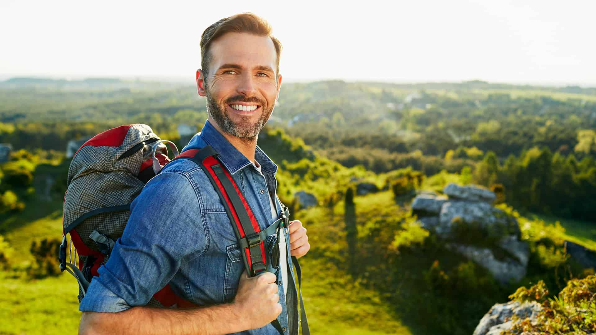 man hiking with backpack on