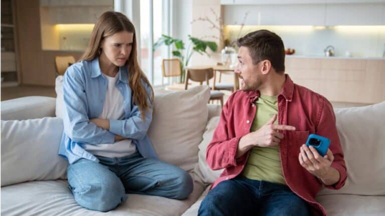 A couple arguing with a phone in hand.