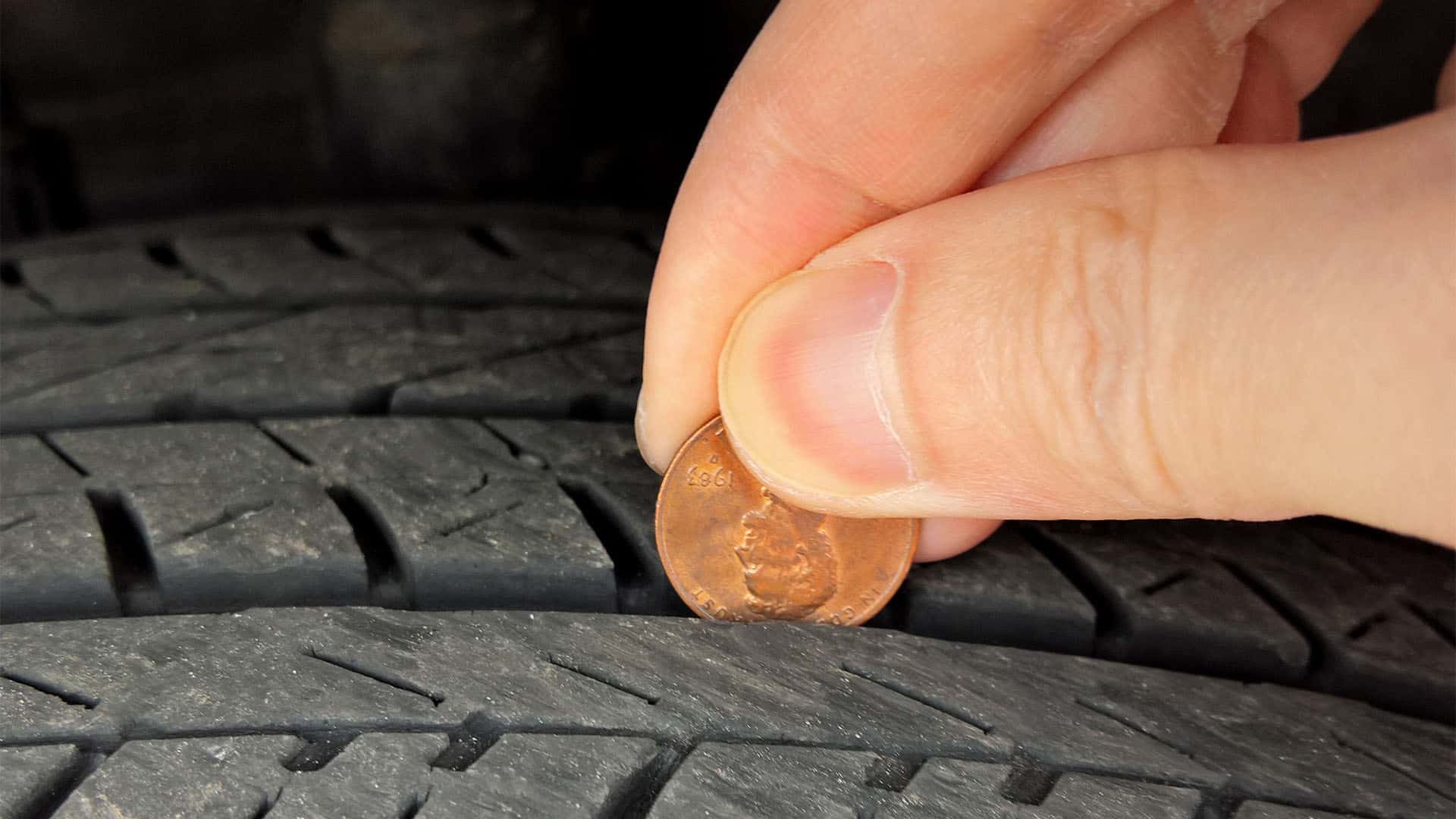 Measure tire thread with a penny.