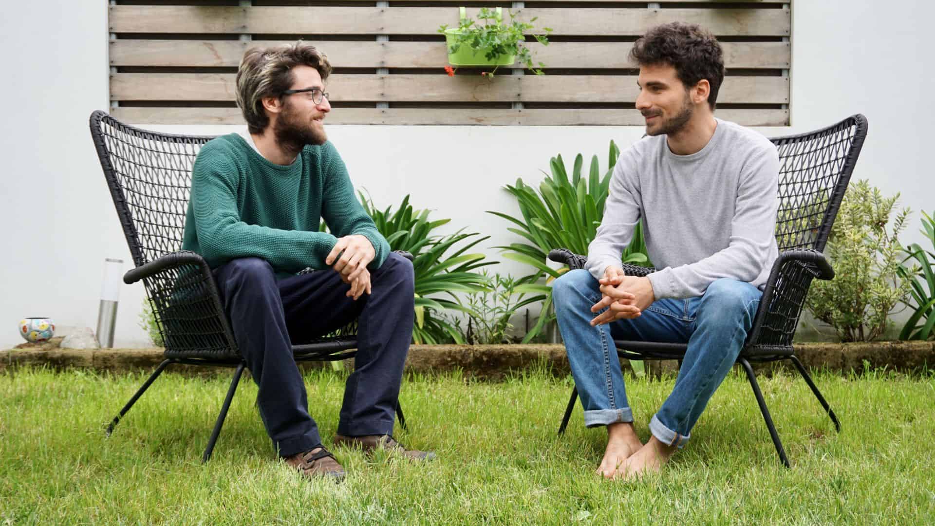 Two Young Adult Men Talking.