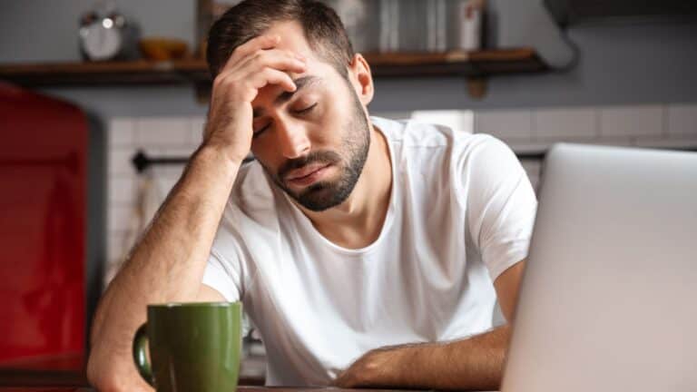 tired man sitting in front of computer.