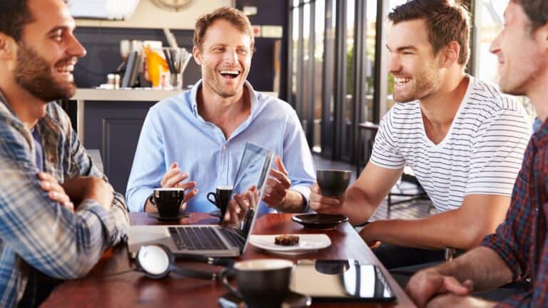 Men laughing having lunch together