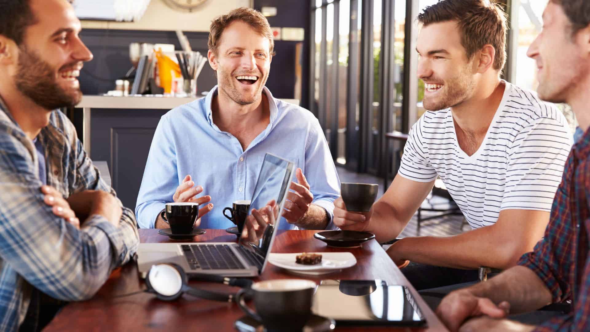 Men laughing having lunch together