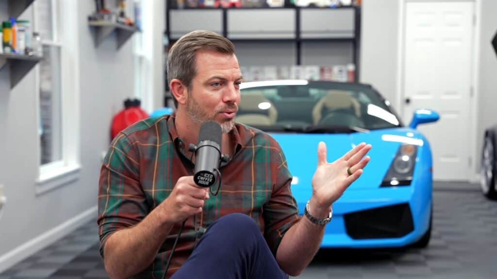 Lamborghini saleseman in an interview sitting in front of a luxury sports car