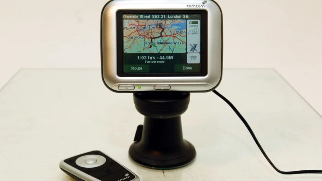 An old hand-help TomTom GPS unit on a mount