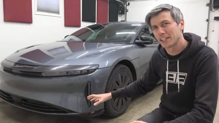 YouTuber in his garage next to his Lucid Air Touring