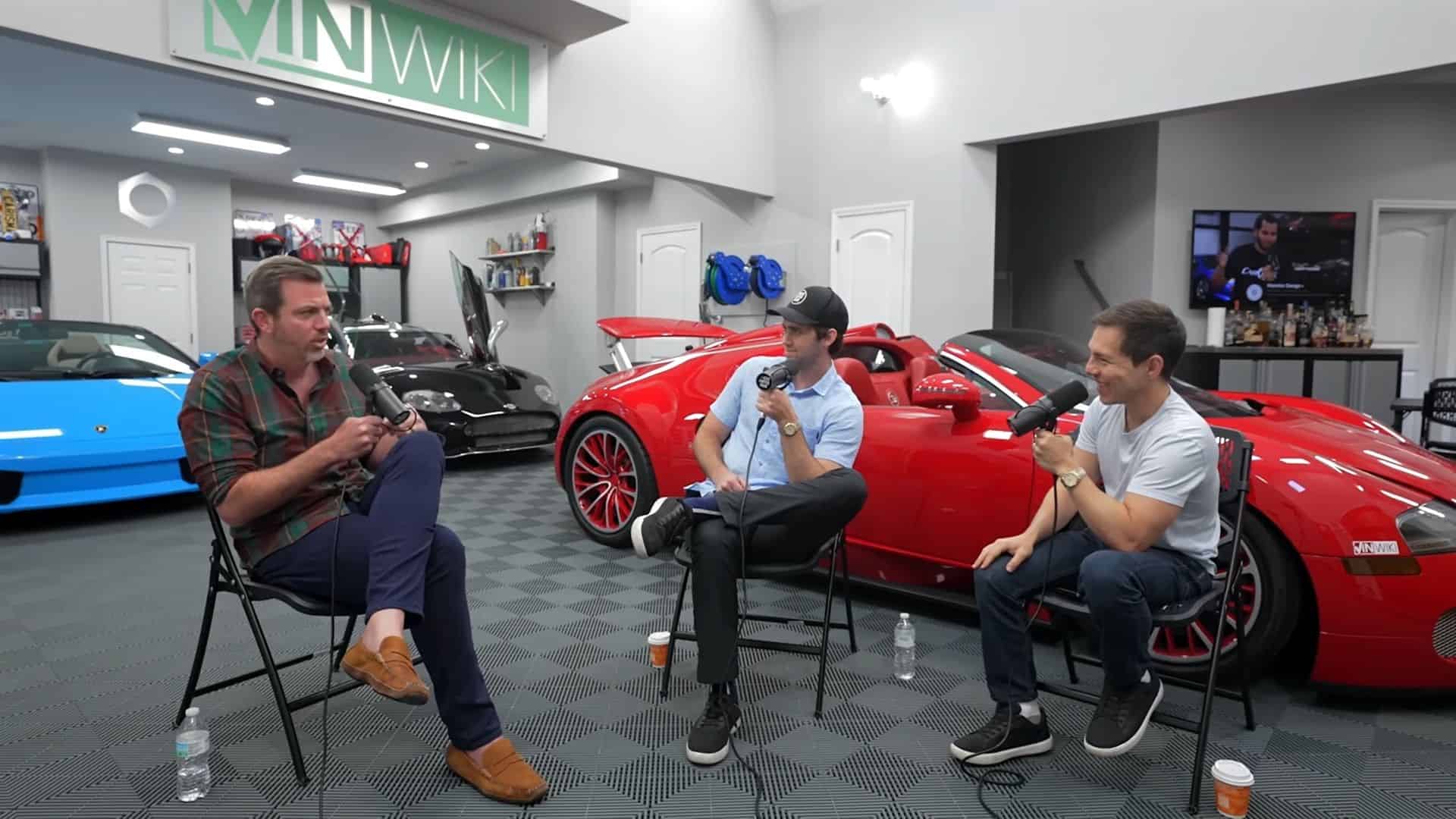 Three men conducting a podcast interview sitting in a garage of luxury sports cars