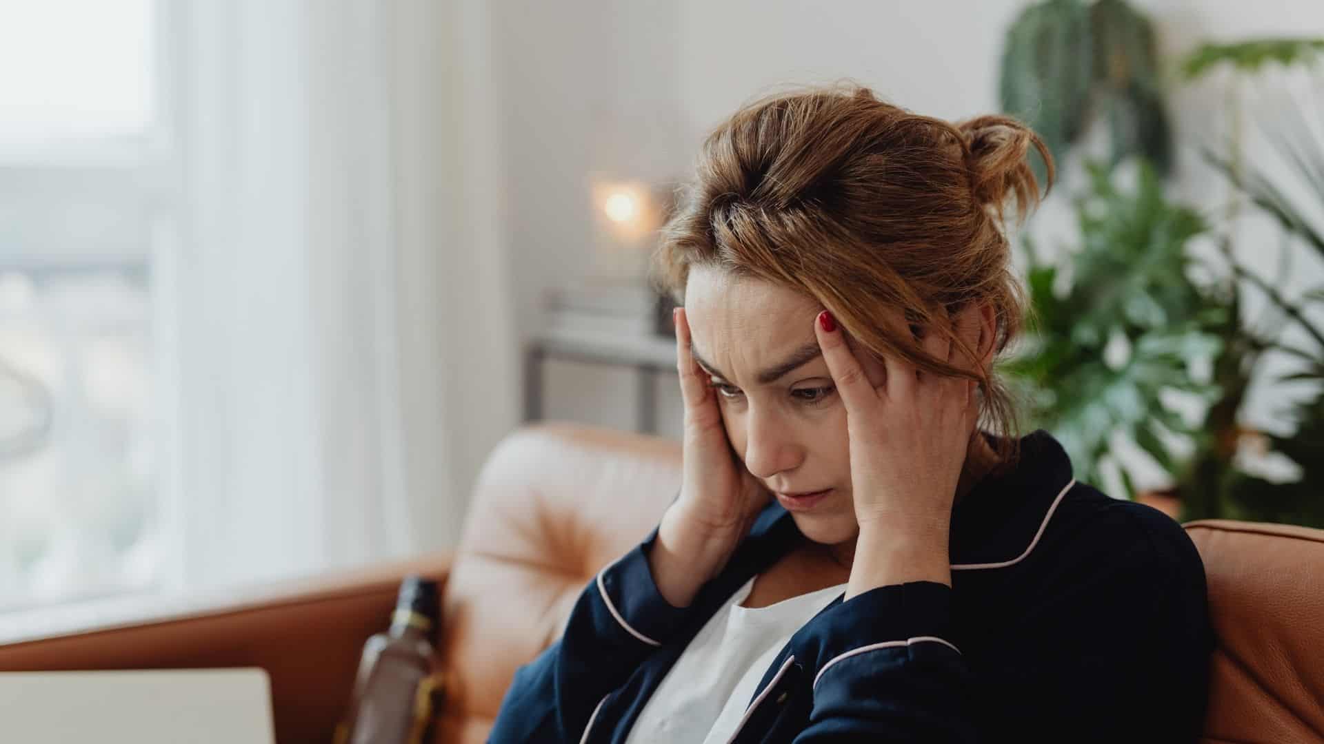 Stressed woman holding her head in frustration