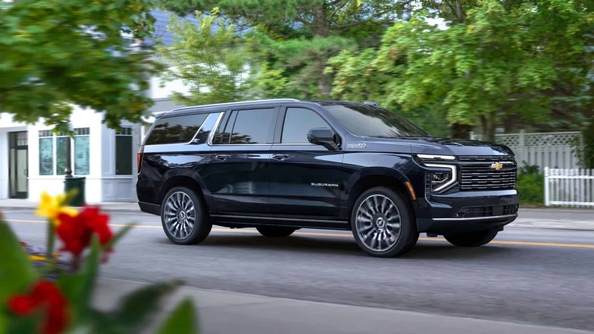 2025 Chevy Suburban driving down neighborhood road
