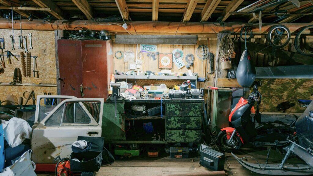 Inside of a garage with miscellaneous clutter