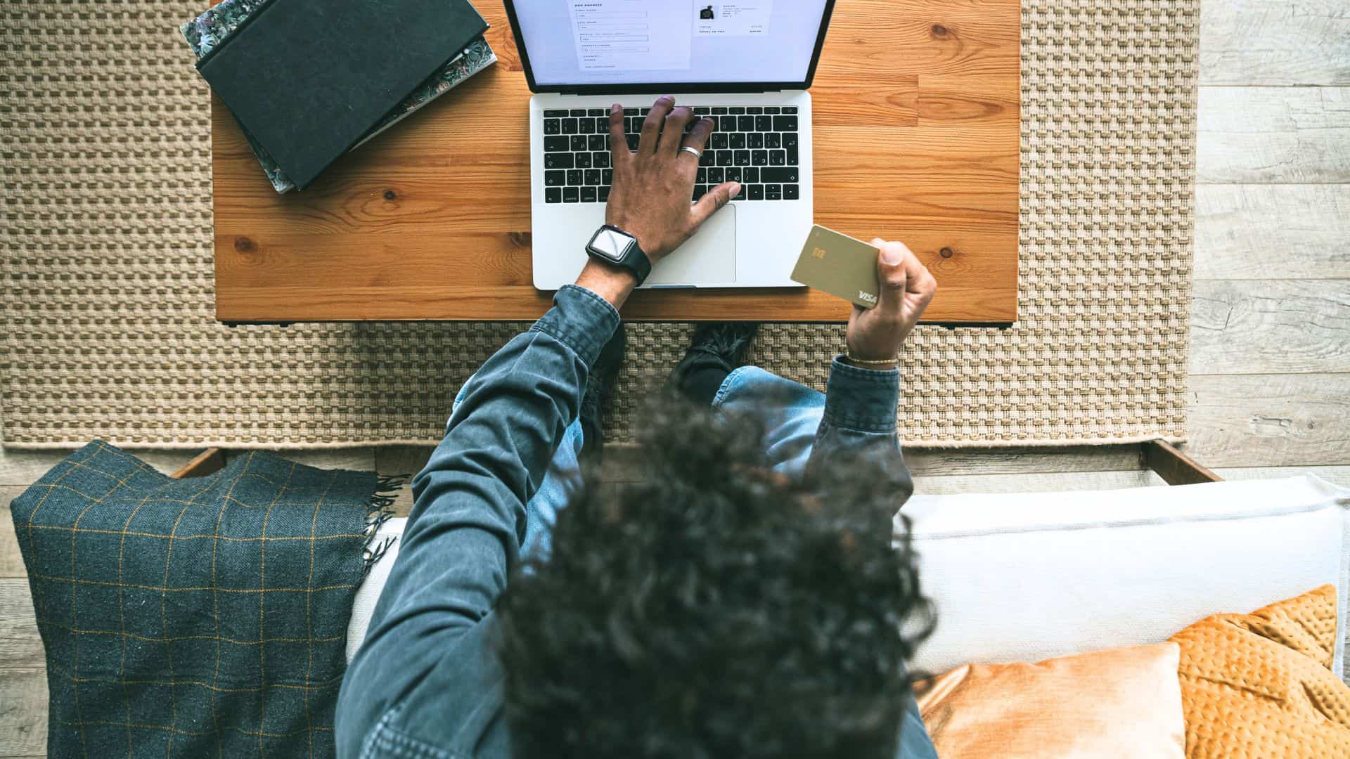 Modern man shopping online with credit card and laptop at home, lifestyle, technology, relaxation, masculinity.