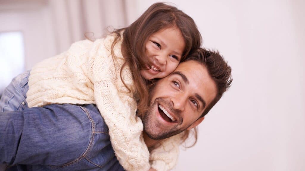 Man with his daughter on back