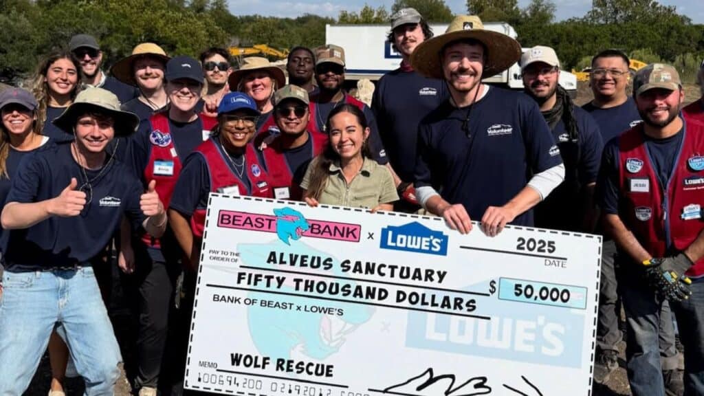 Mr Beast holding a cheque standing with a group of people