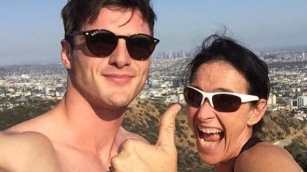 Actor Jacob Elordi and his mom Melissa sharing smiles and a thumbs up atop a hiking trail overlooking the city