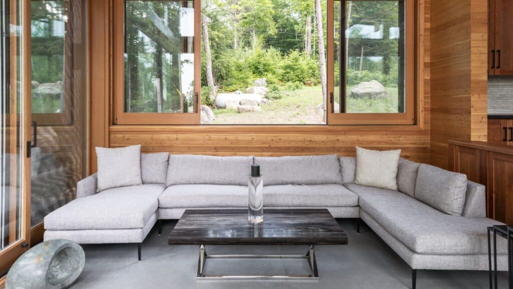 Cozy sunroom with panoramic garden views and natural wood accents