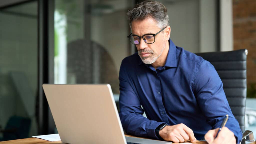 Man in front of a computer working.