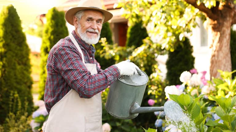 Old man watering plants.