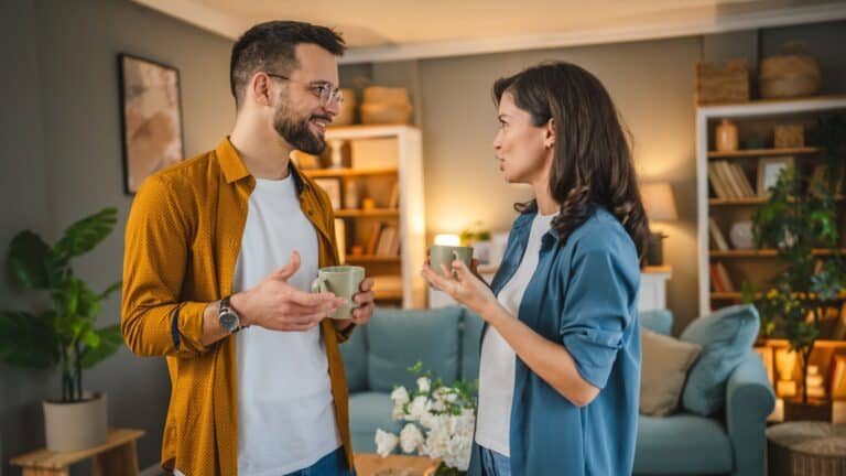man and woman talking in home