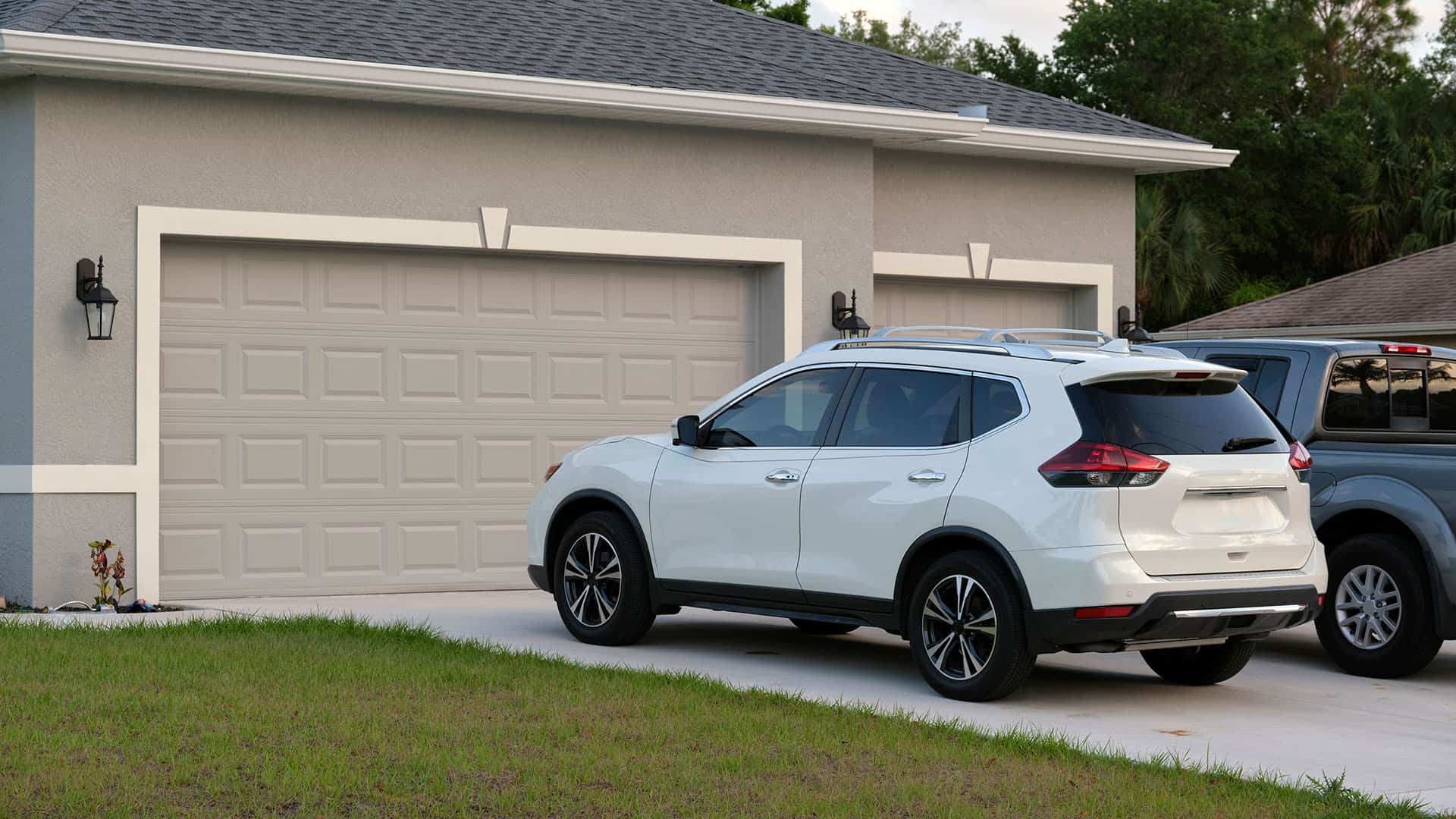 Car parks in front of a garage.