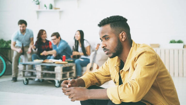 Man isolated from friends.