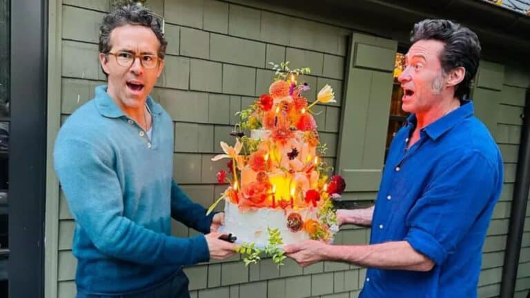 Hugh Jackman and Ryan Reynolds sharing "birthday month" cake