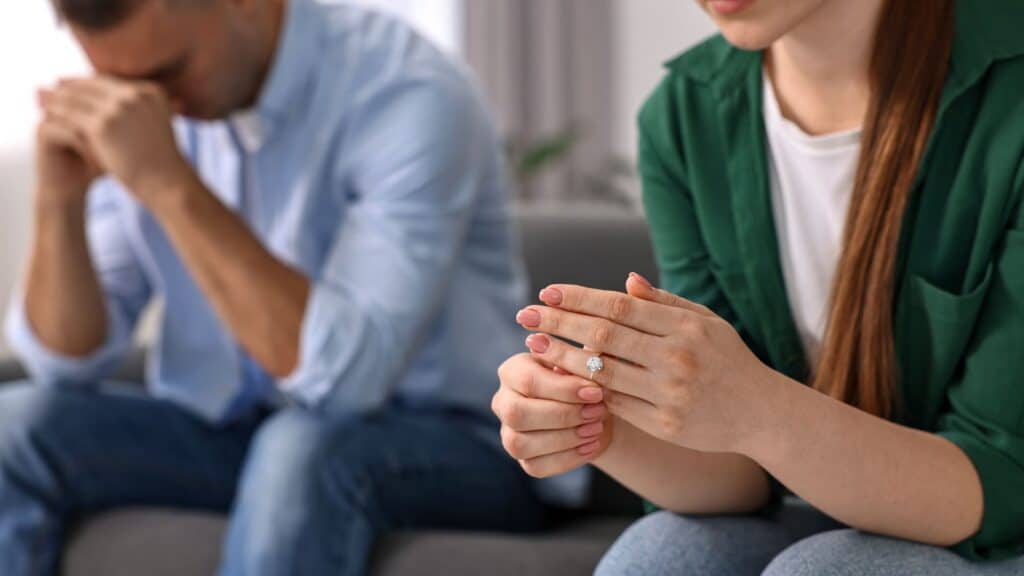 Woman taking off engagement ring