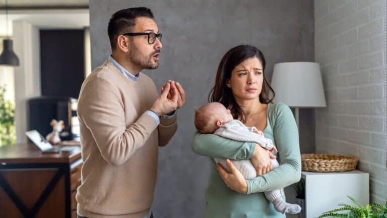 man arguing with his wife who is holding a baby