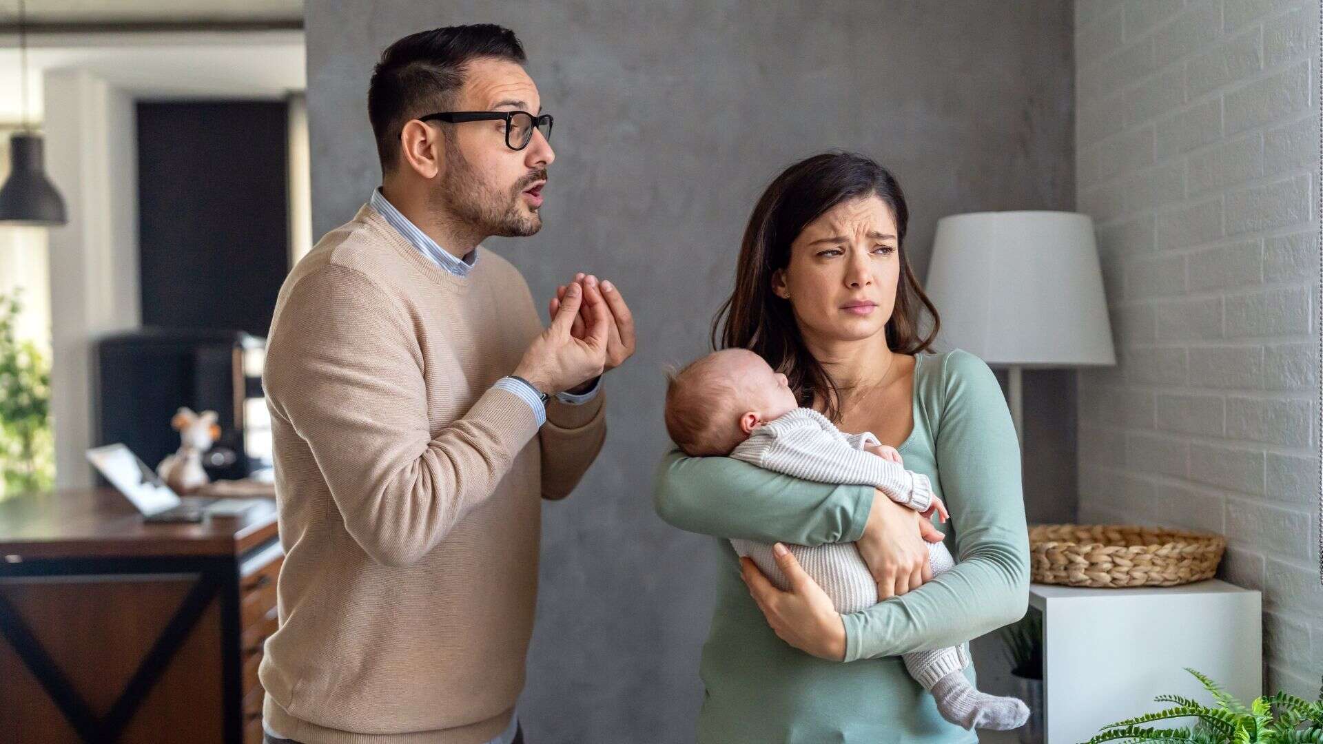 man arguing with his wife who is holding a baby