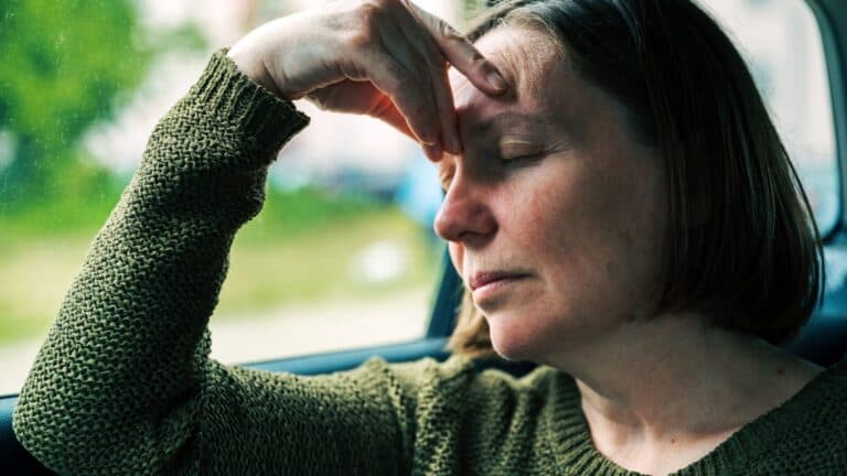 woman suffering from motion sickness in a car