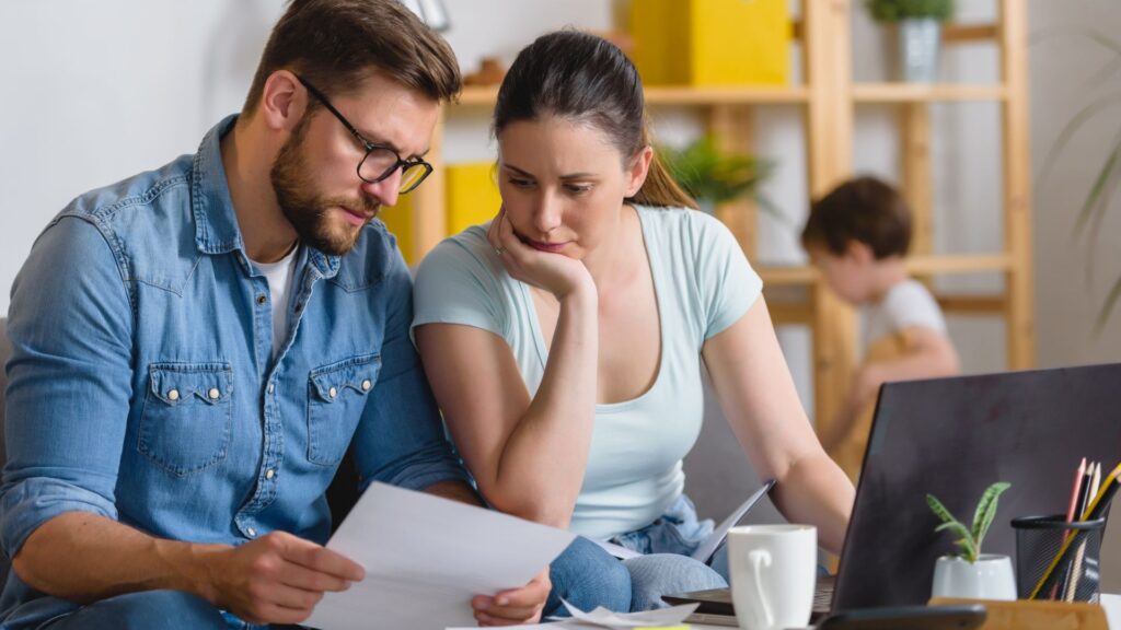 Family with a child having financial problems, doing home budgeting, calculating expenses