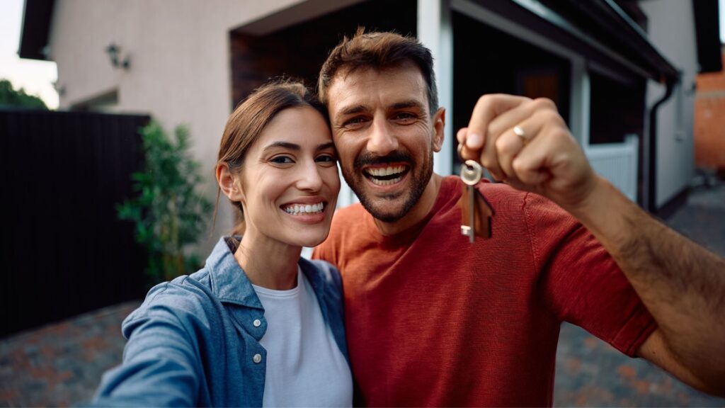 Happy couple holding house keys