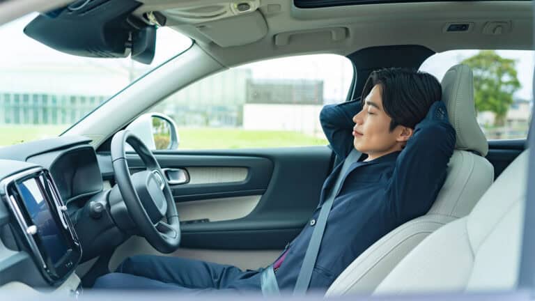 Man sleeping in a car.