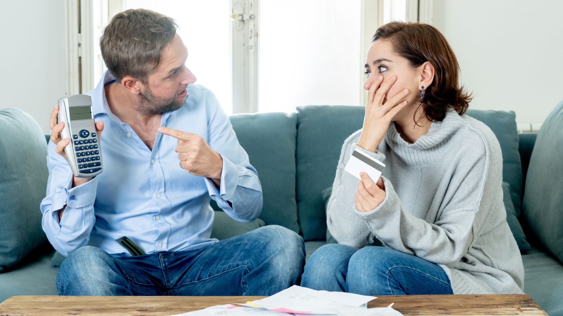 Stressed couple arguing over credit card