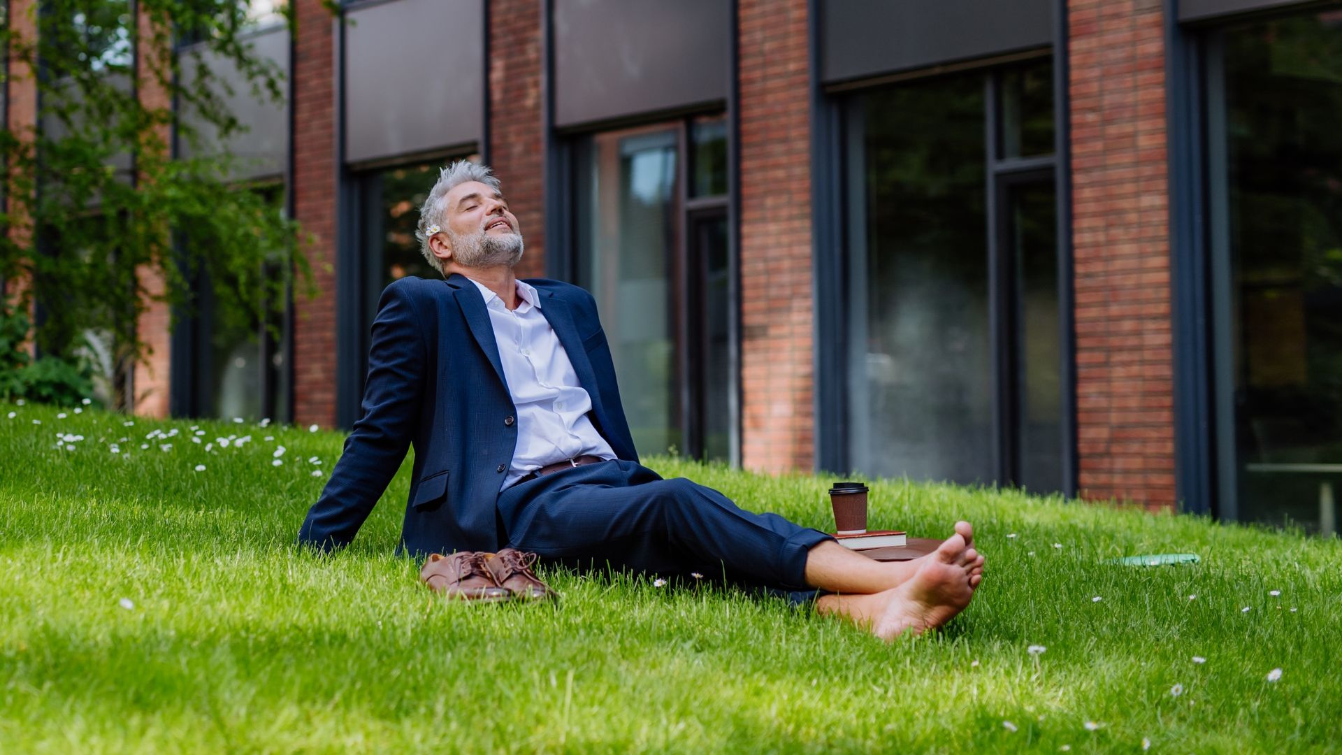 businessman resting and sitting barefoot in park