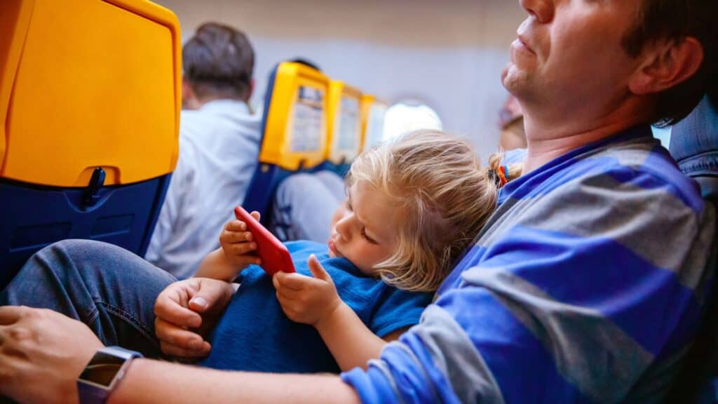 father holding his baby during flight