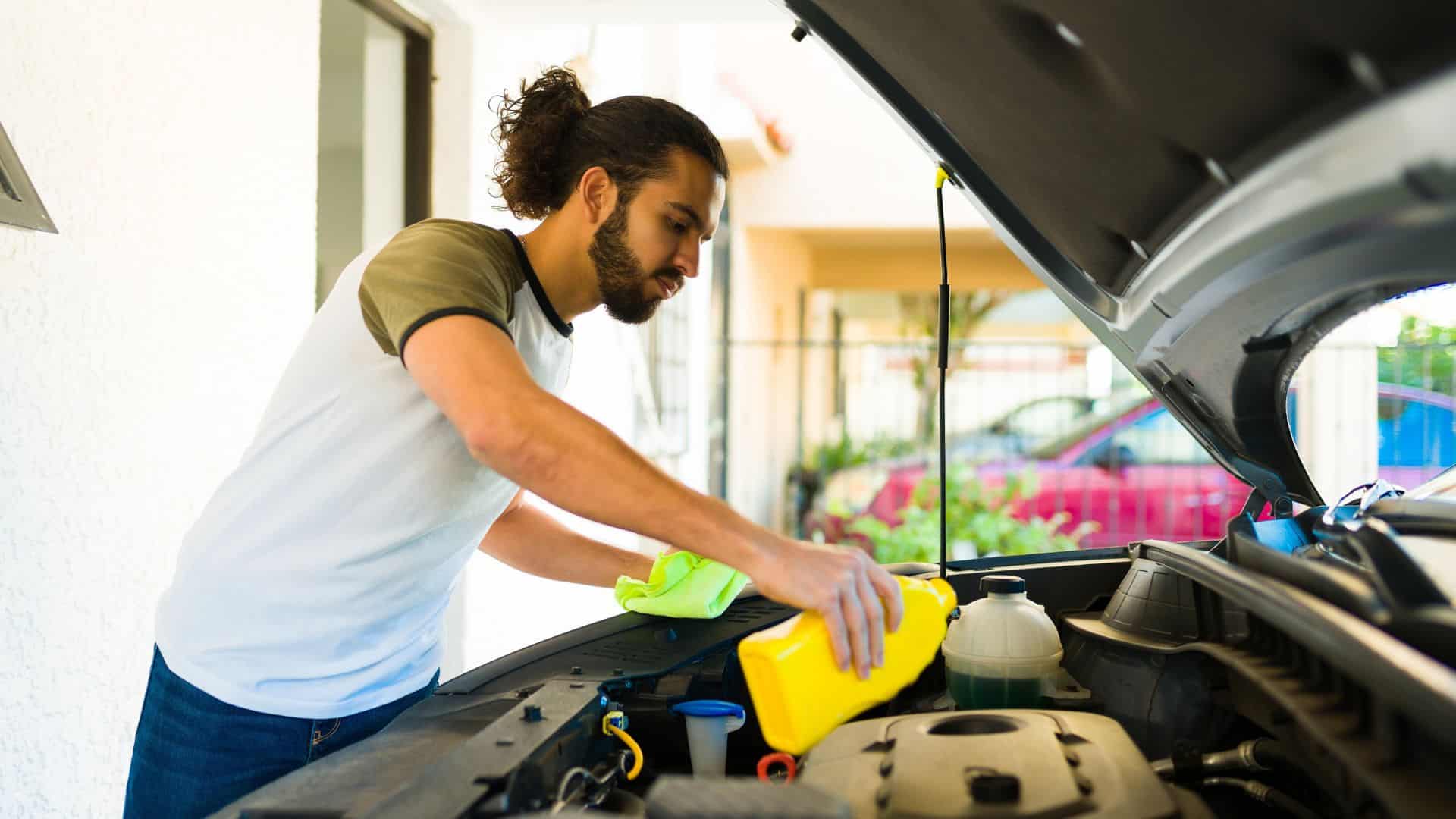 man changing the oil of his car