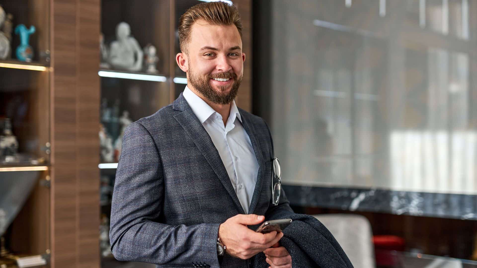 man in suit with a smartphone in his hand
