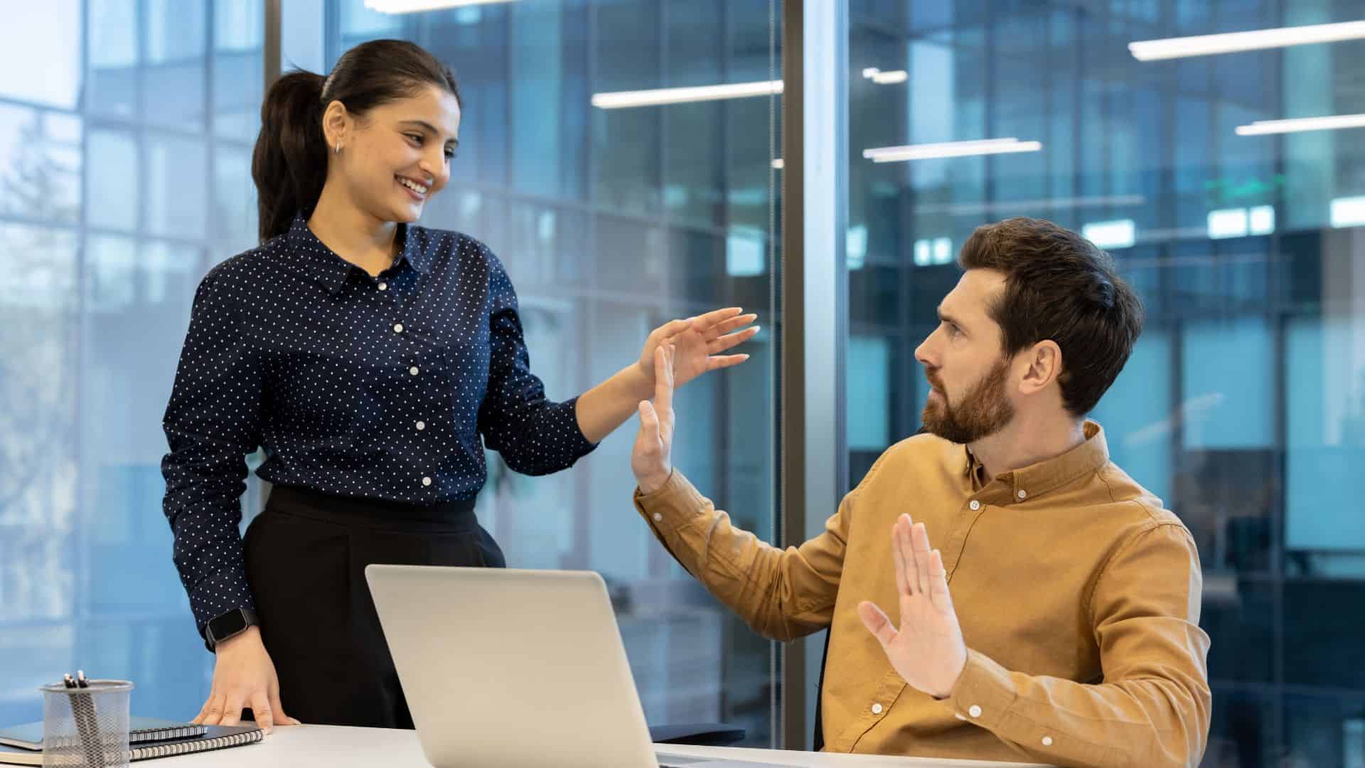 man signaling no to a woman at work