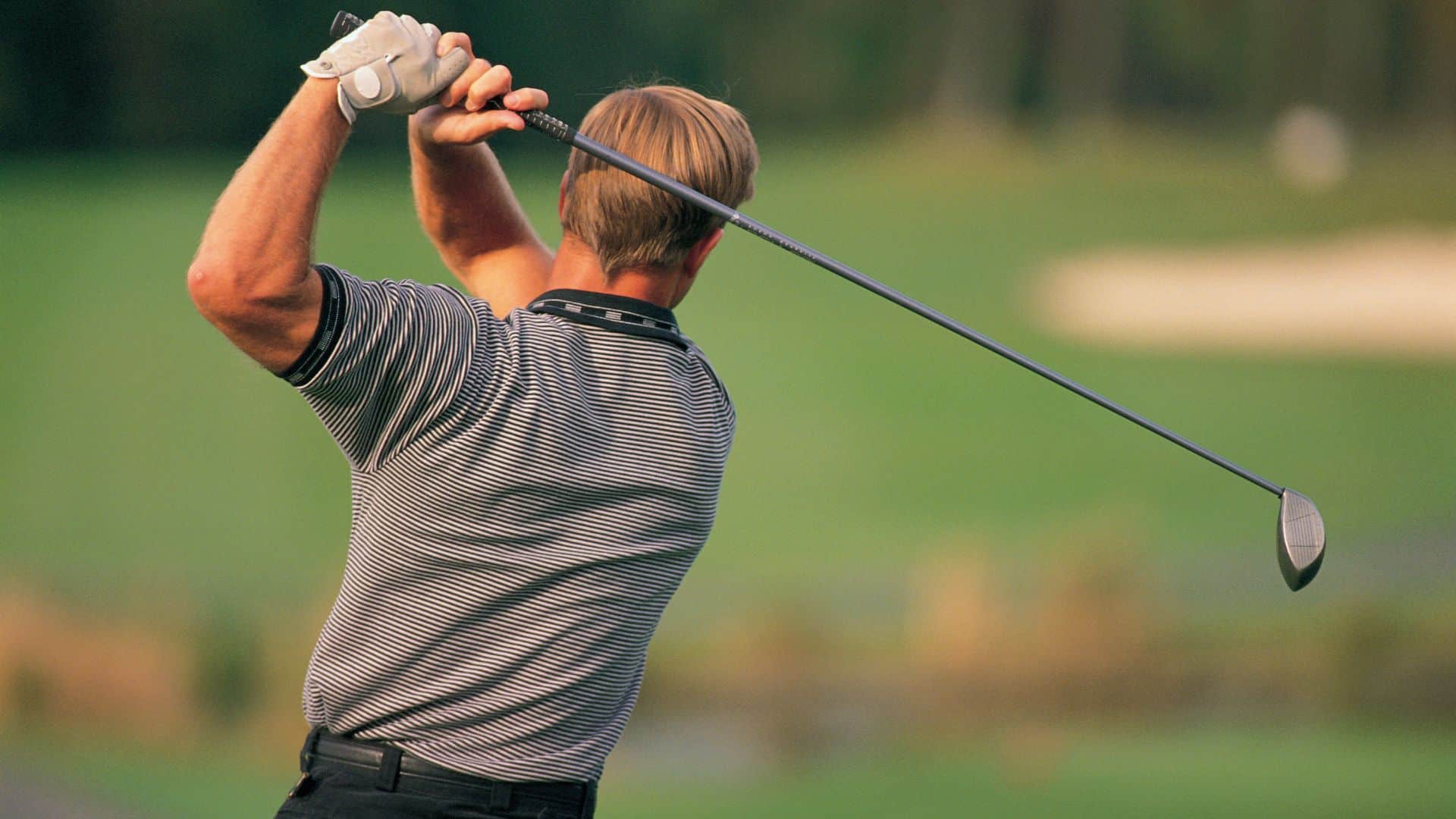A man swinging a golf club
