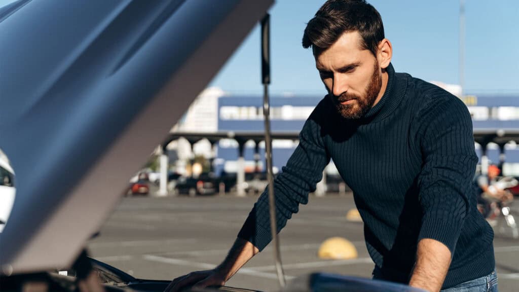 A man checking a car