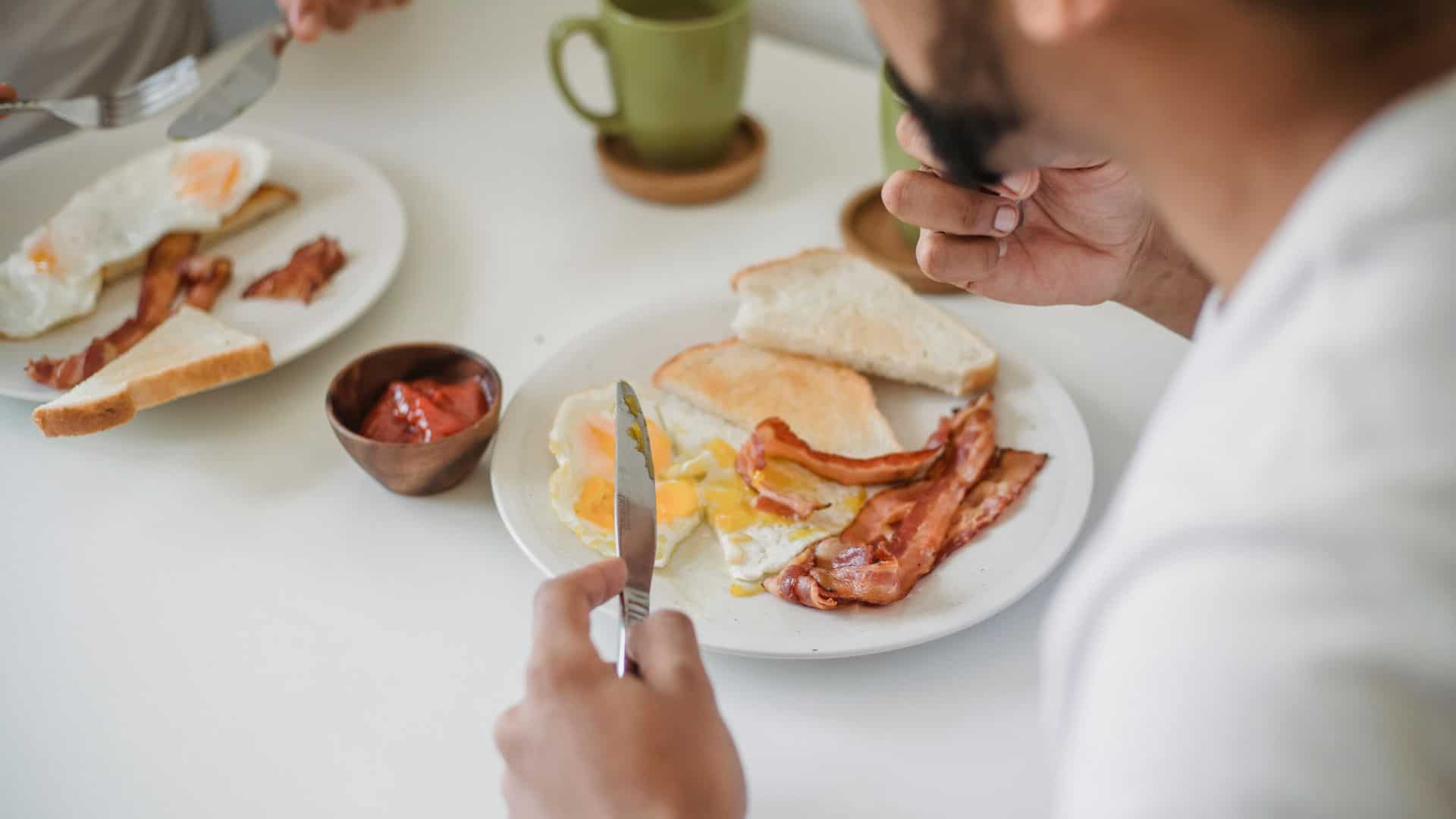 A man is eating breakfast.