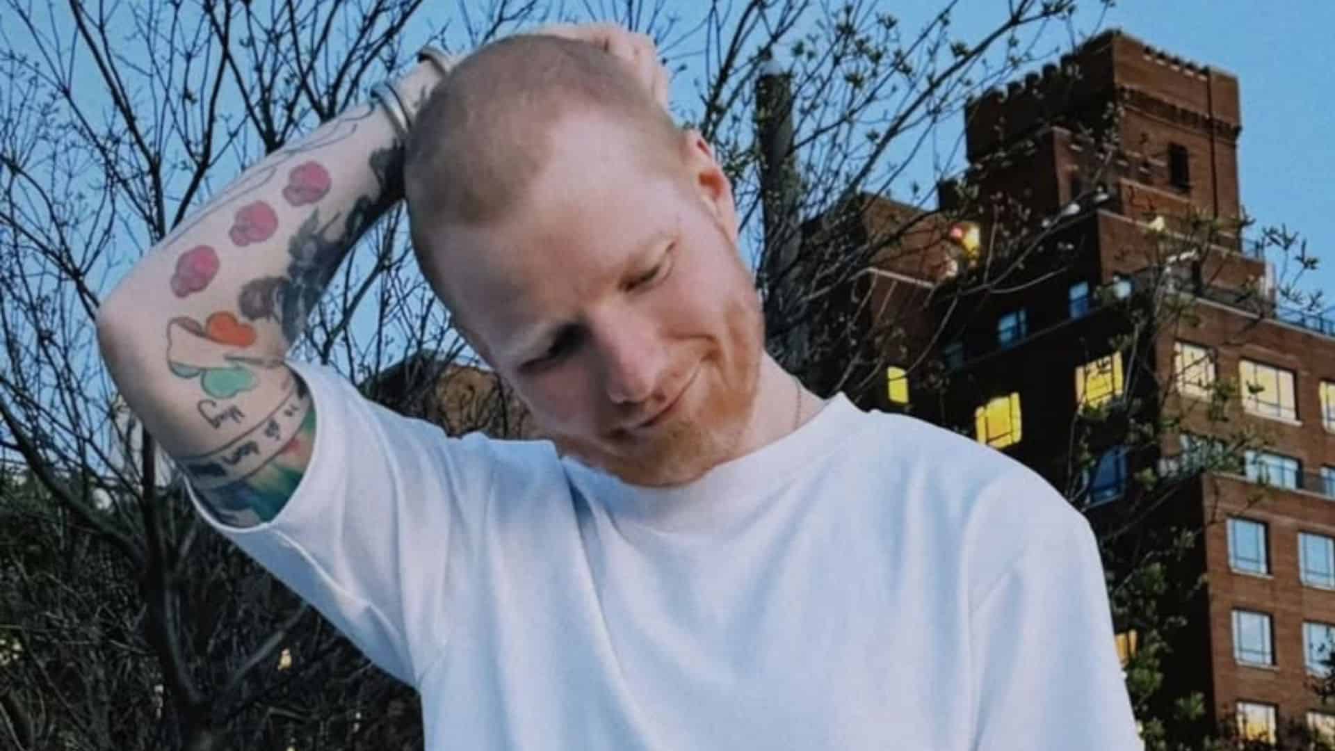 Ed Sheeran touching his shaved head