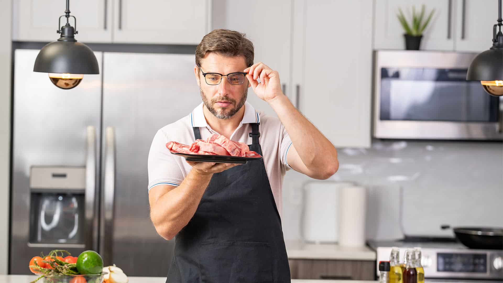 Man cooking steak at home