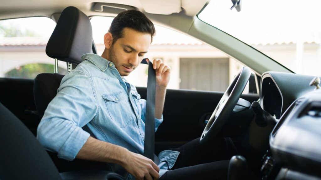 A man fastening his seatbelt